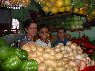 Friendly Costa Ricans sell produce at the farmers market in Atenas, Costa Rica